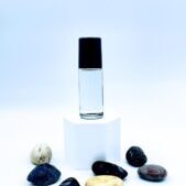 Clear glass bottle on pedestal with stones
